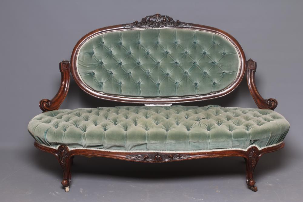 A VICTORIAN WALNUT SHOWFRAME SALON SOFA button upholstered in pale green dralon Image