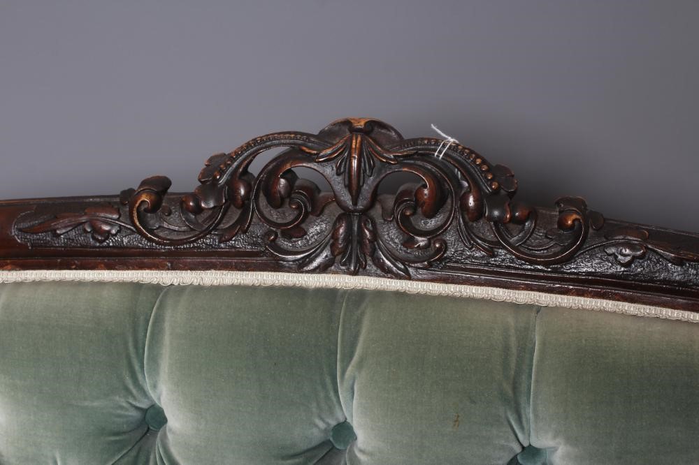 A VICTORIAN WALNUT SHOWFRAME SALON SOFA button upholstered in pale green dralon Image