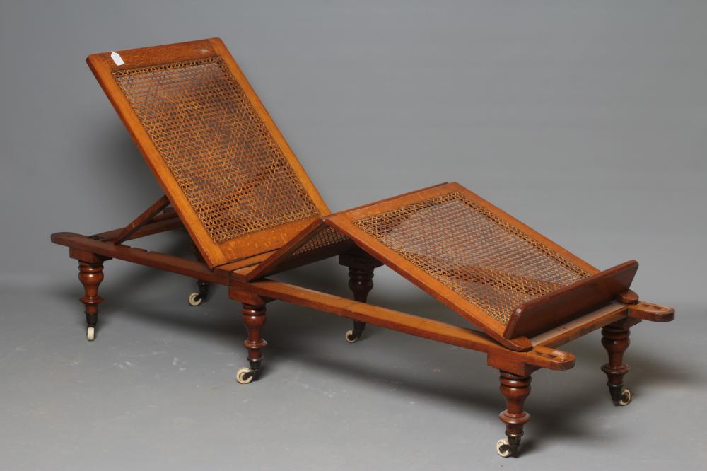 A VICTORIAN ROBINSONS OAK "ILKLEY COUCH" in the campaign style with adjustable caned panels Image