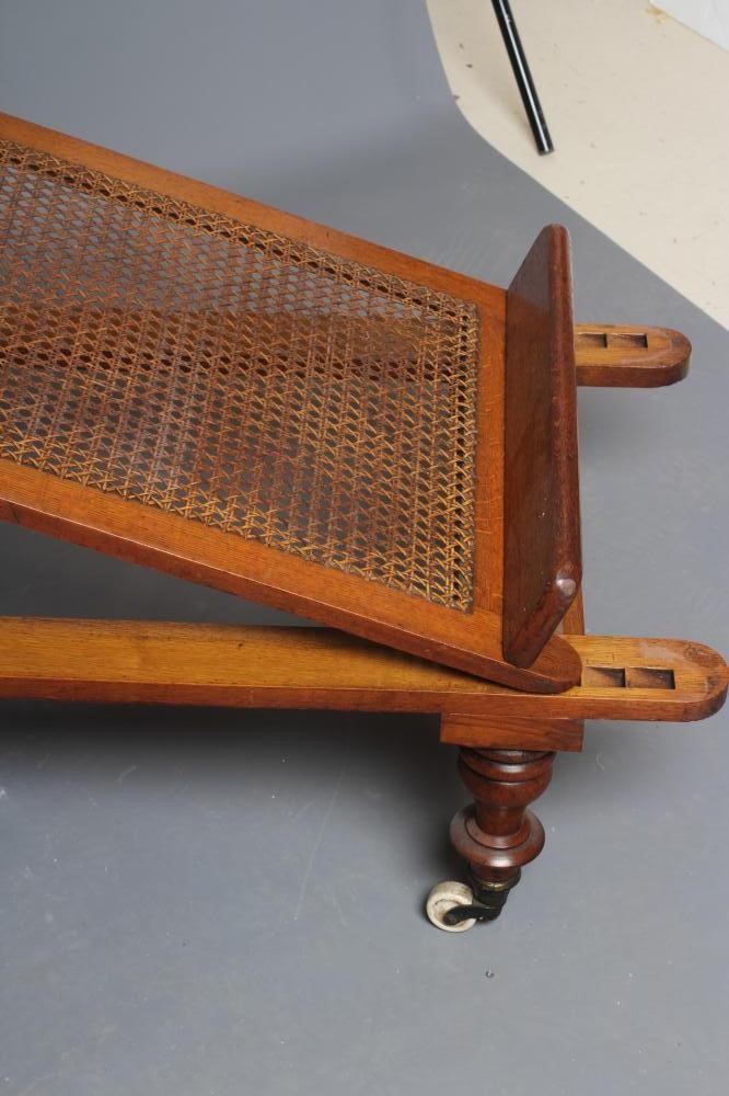 A VICTORIAN ROBINSONS OAK "ILKLEY COUCH" in the campaign style with adjustable caned panels Image