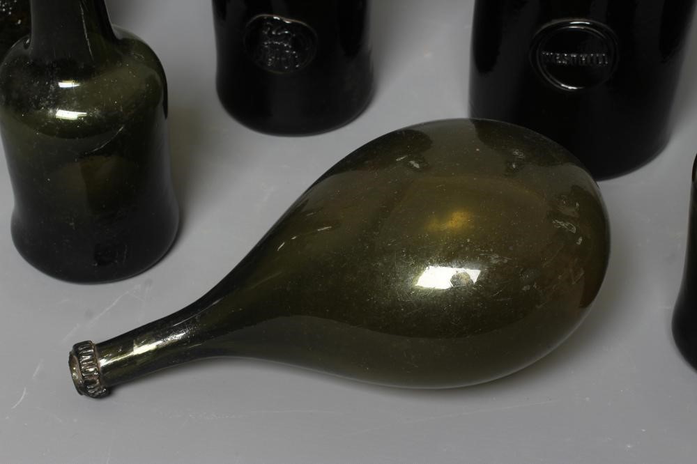 SEVEN GREEN GLASS BOTTLES including a wine bottle with a griffin seal Image
