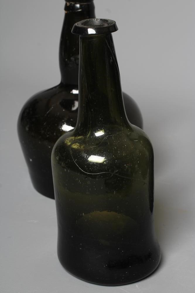 SEVEN GREEN GLASS BOTTLES including a wine bottle with a griffin seal Image