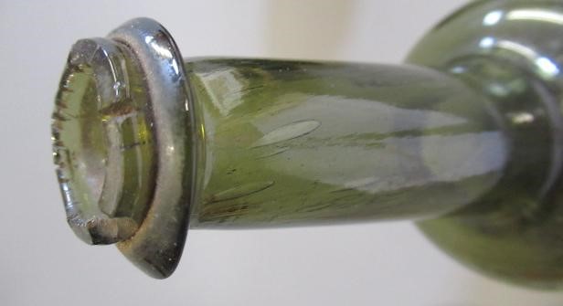 SEVEN GREEN GLASS BOTTLES including a wine bottle with a griffin seal Image