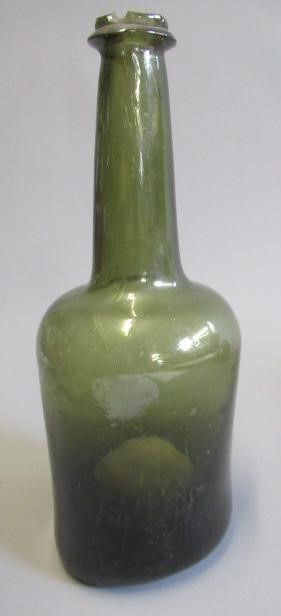 SEVEN GREEN GLASS BOTTLES including a wine bottle with a griffin seal Image