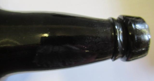 SEVEN GREEN GLASS BOTTLES including a wine bottle with a griffin seal Image