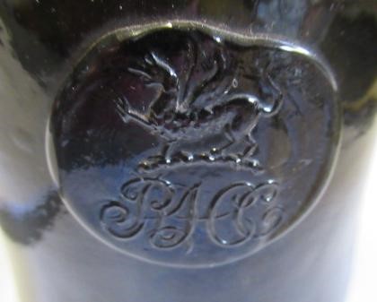 SEVEN GREEN GLASS BOTTLES including a wine bottle with a griffin seal Image