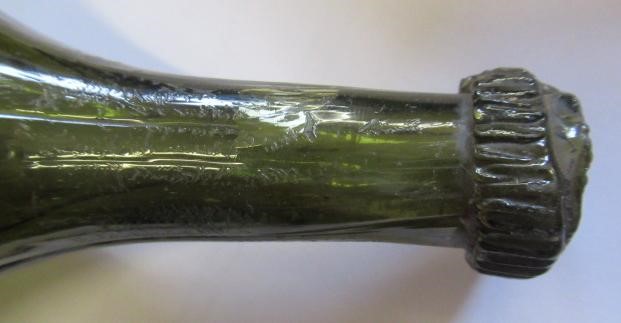 SEVEN GREEN GLASS BOTTLES including a wine bottle with a griffin seal Image