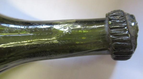 SEVEN GREEN GLASS BOTTLES including a wine bottle with a griffin seal Image