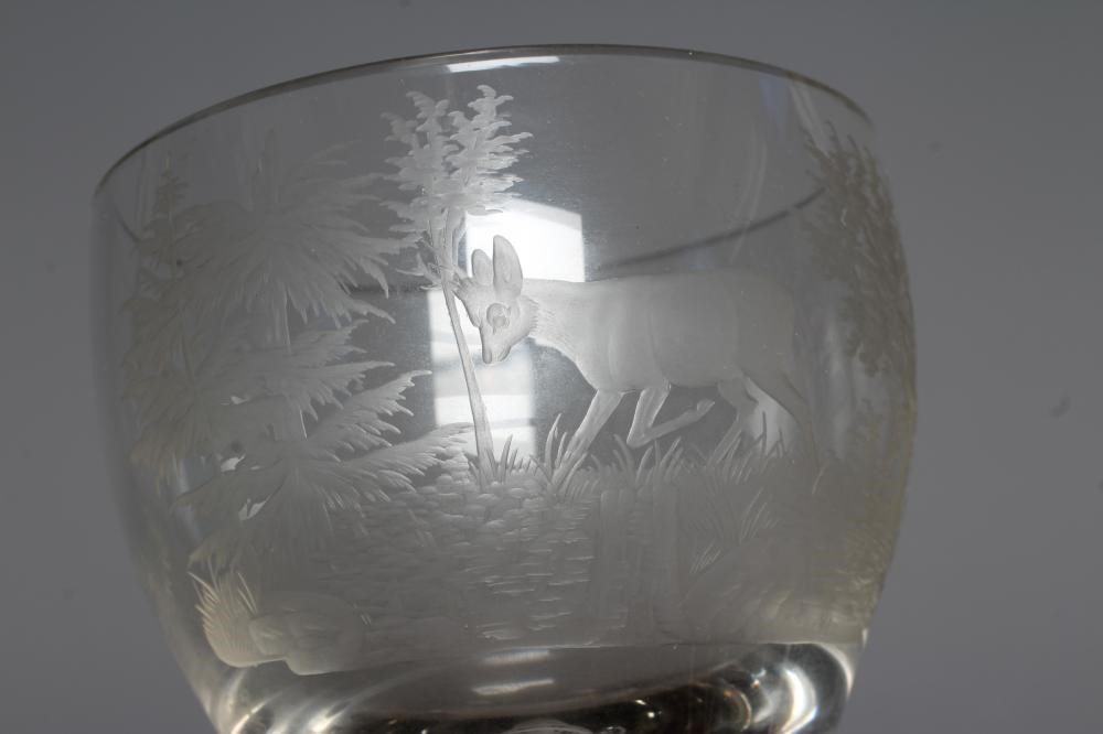 AN OUTSIZE CORDIAL GLASS, the rounded bowl engraved with a stag in a wooded glade, on an opaque Image