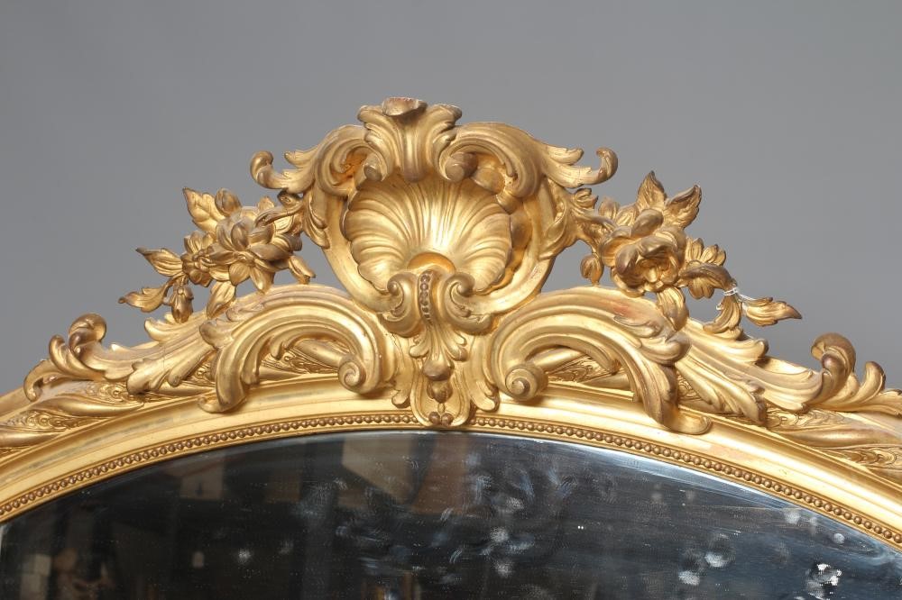 A CARVED GILTWOOD AND GESSO OVERMANTEL MIRROR Image