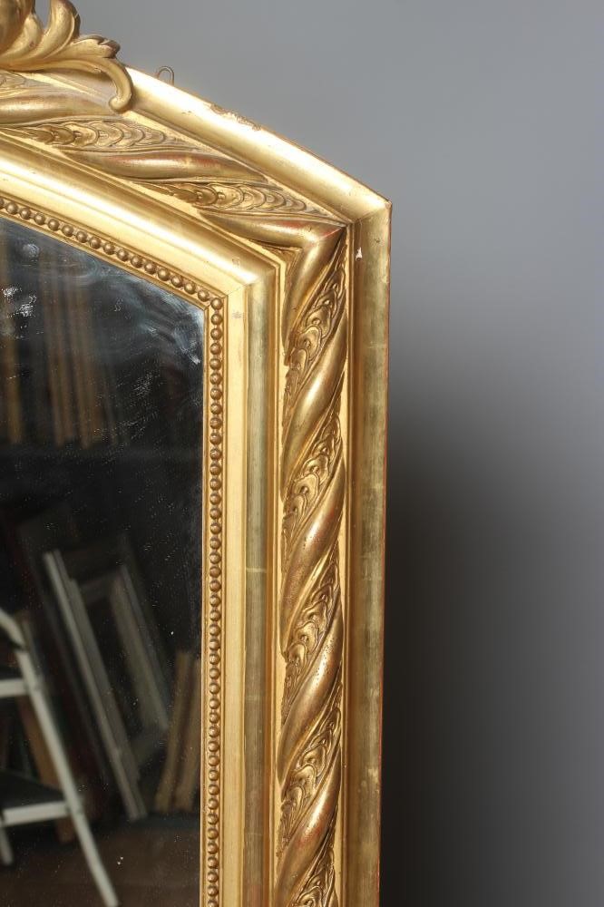 A CARVED GILTWOOD AND GESSO OVERMANTEL MIRROR Image