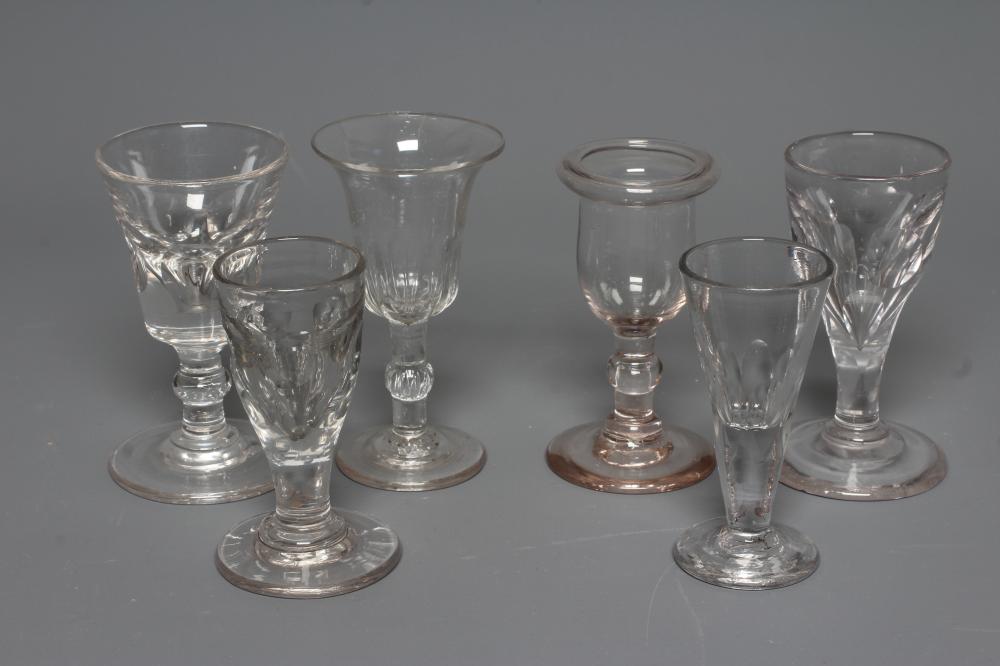 FIVE GEORGIAN CORDIAL GLASSES, five with panelled bowls, together with a Georgian dwarf candlestick Image
