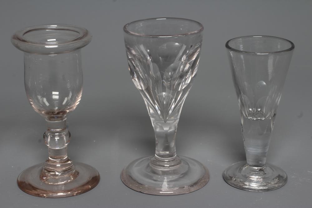 FIVE GEORGIAN CORDIAL GLASSES, five with panelled bowls, together with a Georgian dwarf candlestick Image
