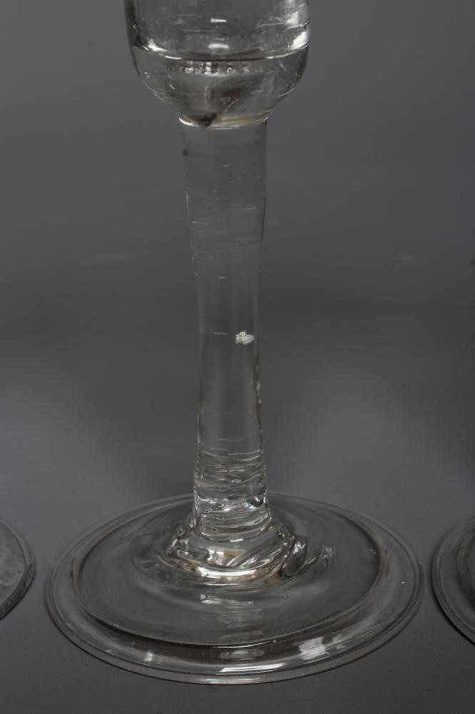 THREE GEORGIAN CORDIAL GLASSES comprising a round funnel bowl on plain cylindrical stem and folded Image