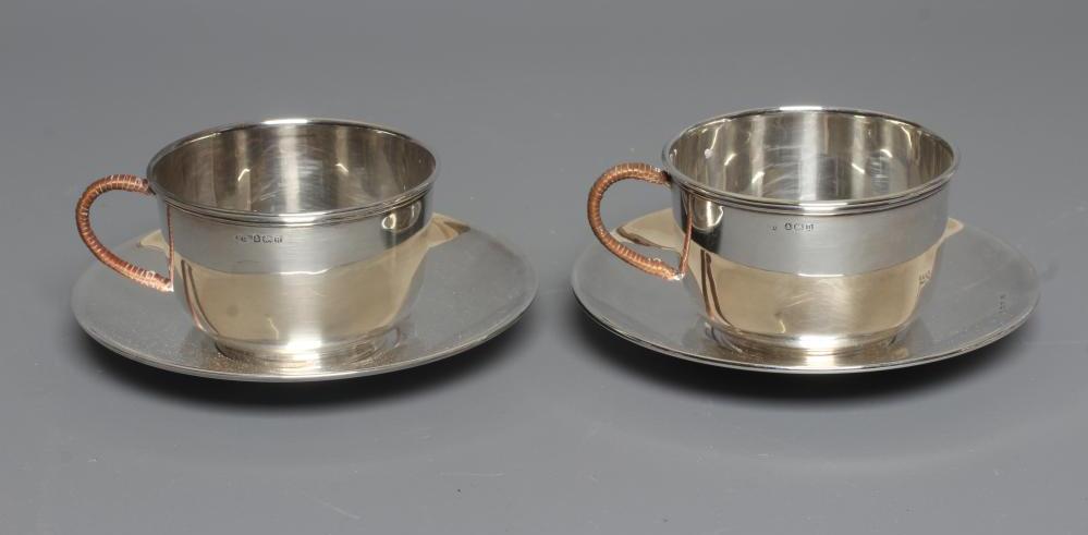 A PAIR OF GEORGE V SILVER TEA CUPS AND SAUCERS by William Devonport Image