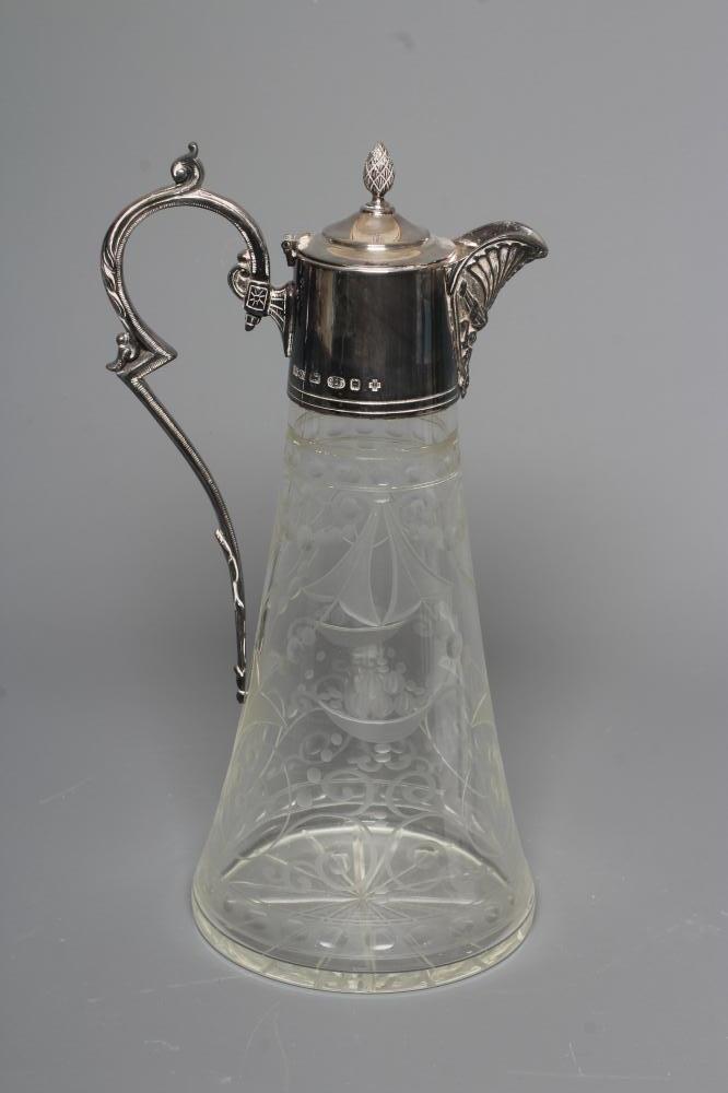 AN ELIZABETH II SILVER MOUNTED GLASS CLARET JUG of swept cylindrical form Image