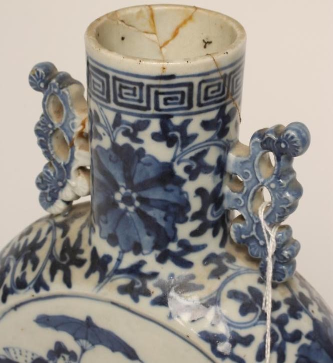 A CHINESE PORCELAIN MOONFLASK painted in underglaze blue with two roundels enclosing travelling Image