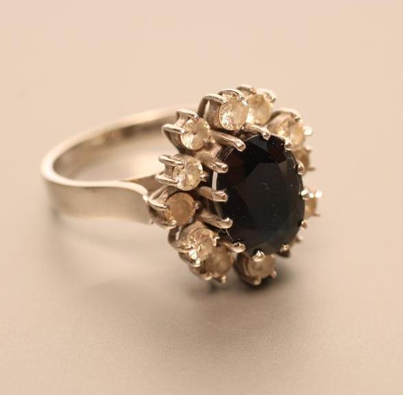 A SAPPHIRE AND DIAMOND CLUSTER RING Image