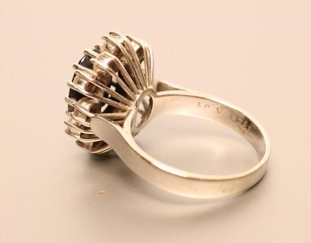 A SAPPHIRE AND DIAMOND CLUSTER RING Image