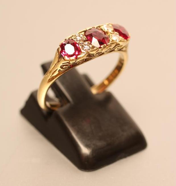 A THREE STONE RUBY RING Image