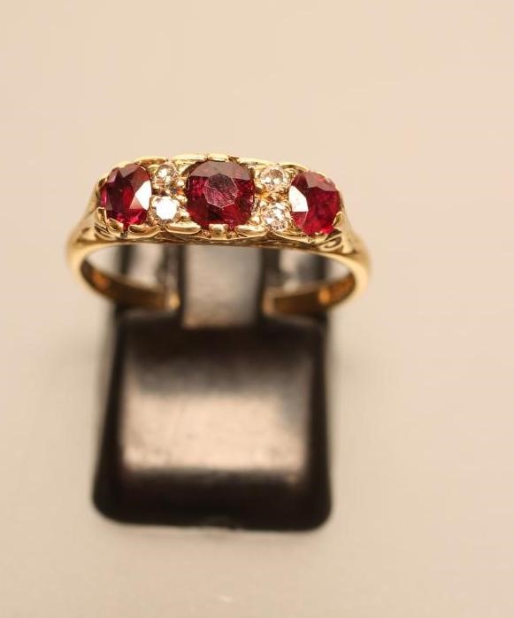 A THREE STONE RUBY RING Image