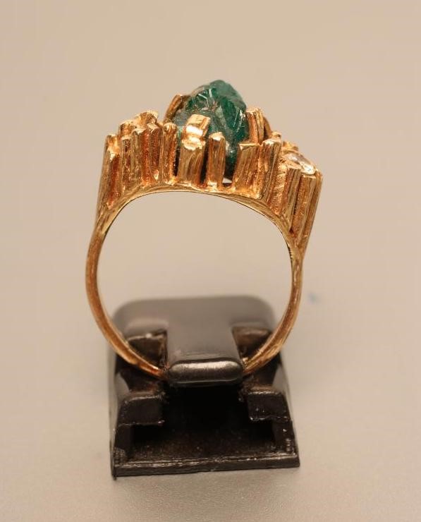 A MODERNIST COCKTAIL RING centred by an uncut dioptase claw set to an asymmetric panel with a small Image