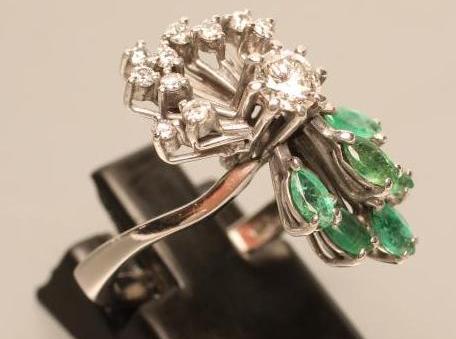 AN EMERALD AND DIAMOND COCKTAIL RING Image