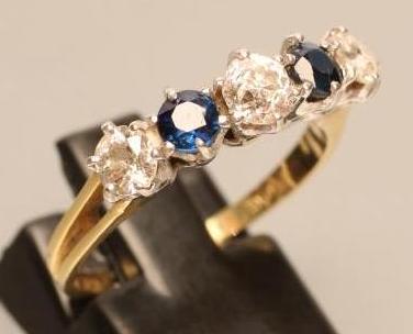 A FIVE STONE DIAMOND AND SAPPHIRE HALF HOOP RING Image