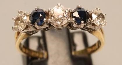A FIVE STONE DIAMOND AND SAPPHIRE HALF HOOP RING Image