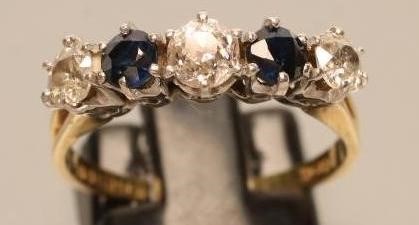 A FIVE STONE DIAMOND AND SAPPHIRE HALF HOOP RING Image