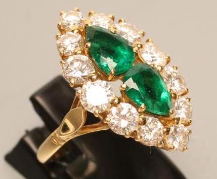 AN EMERALD AND DIAMOND MARQUISE SHAPE CLUSTER RING Image