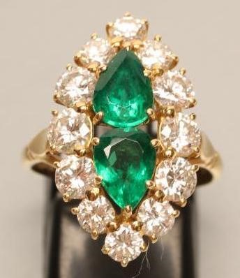 AN EMERALD AND DIAMOND MARQUISE SHAPE CLUSTER RING Image