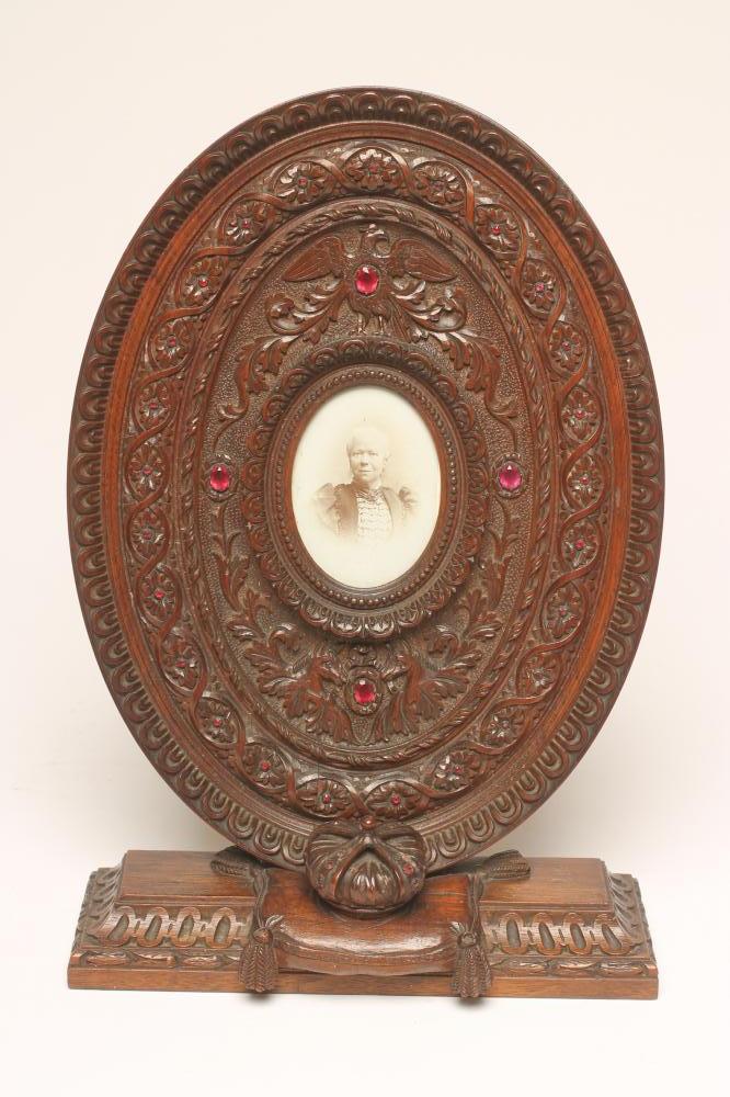 A VICTORIAN OAK FREE-STANDING OVAL FRAME Image