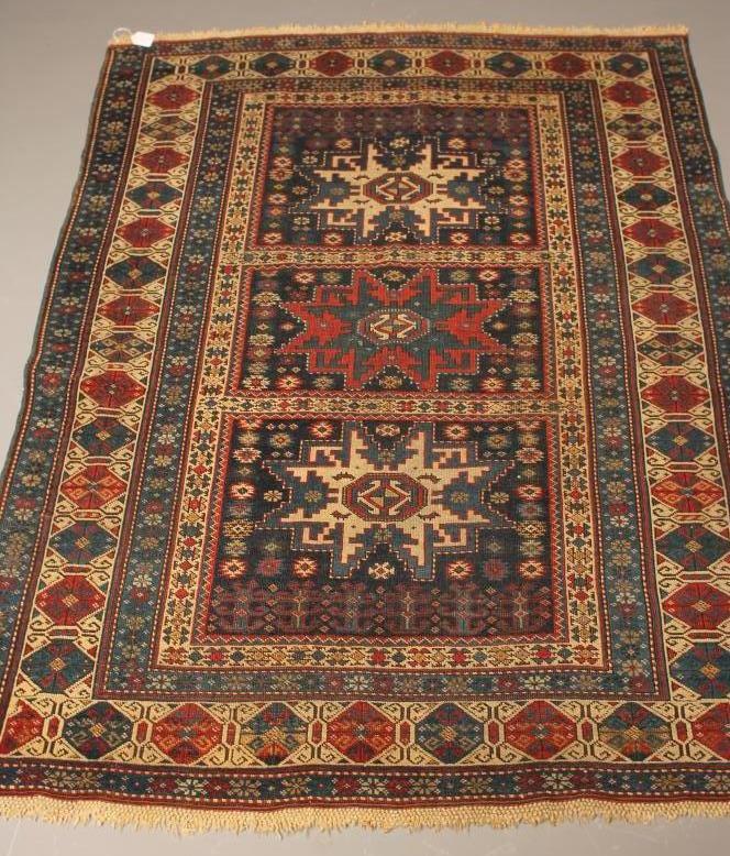 A CAUCASIAN KUBA TRIBAL RUG in navy blue and ivory Image