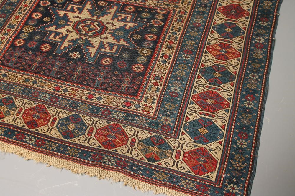 A CAUCASIAN KUBA TRIBAL RUG in navy blue and ivory Image