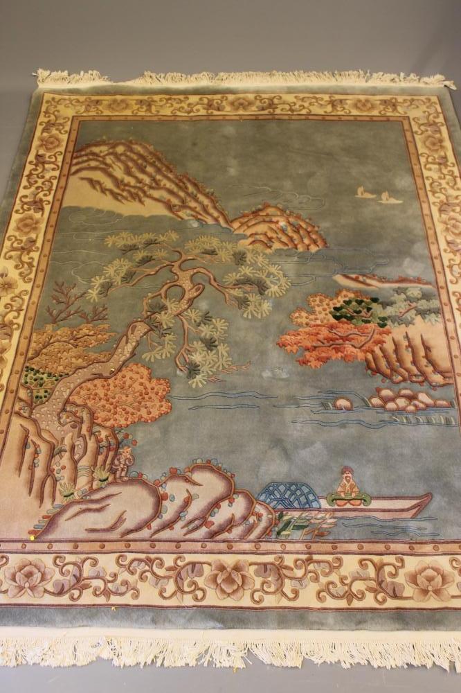 A CHINESE PICTORIAL WASHED AND FRINGED SILK RUG Image