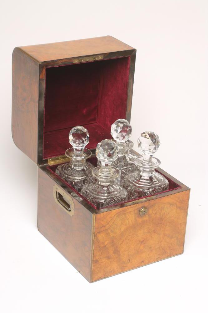 A VICTORIAN BURR WALNUT AND BRASS MOUNTED DECANTER BOX of square form with brass campaign carrying Image