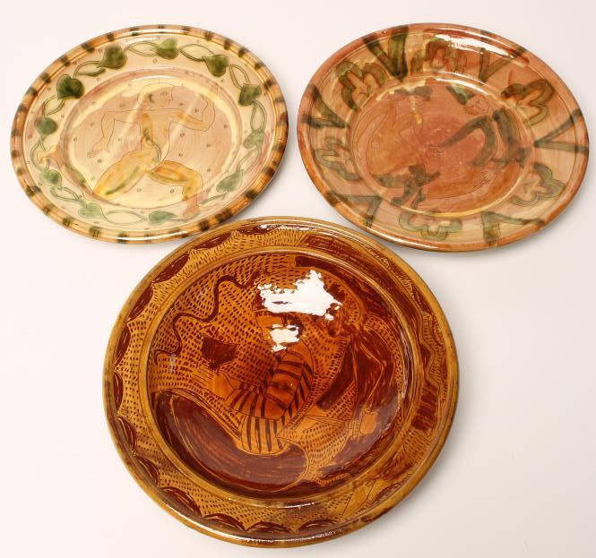 THREE STUDIO TERRACOTTA CHARGERS of plain dished circular form with scraffito type decoration of a Image