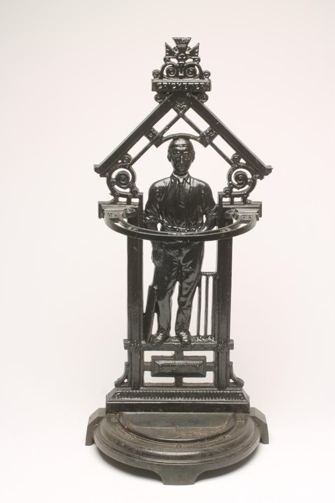 A VICTORIAN CAST IRON "CRICKETER" STICK STAND of semi circular outline with drip tray to base Image