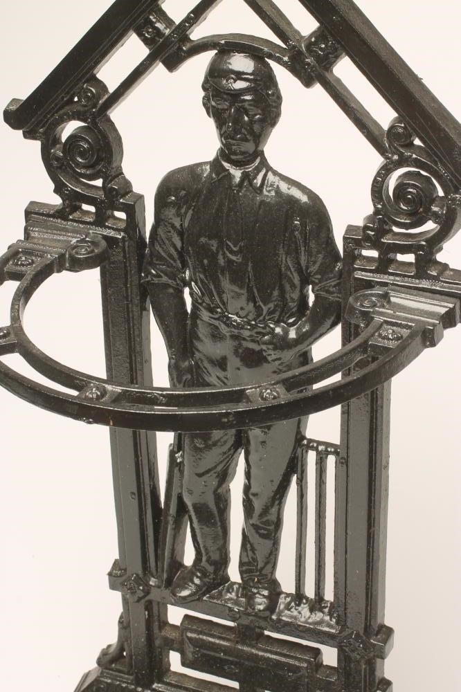 A VICTORIAN CAST IRON "CRICKETER" STICK STAND of semi circular outline with drip tray to base Image