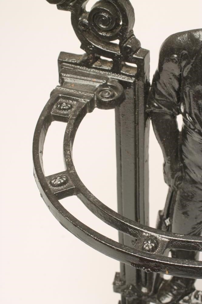 A VICTORIAN CAST IRON "CRICKETER" STICK STAND of semi circular outline with drip tray to base Image