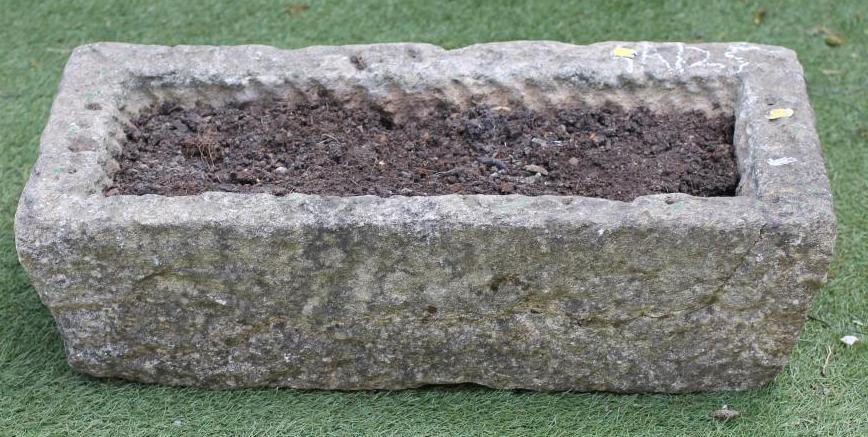 A SANDSTONE TROUGH of shallow oblong form with mildly tapering rusticated sides Image
