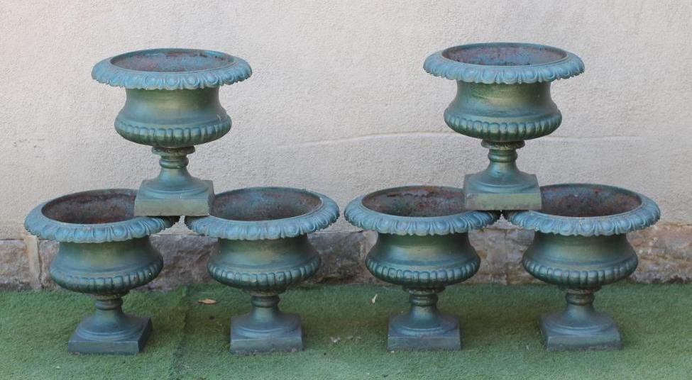 A SET OF SIX CAST IRON URNS of half fluted campana form with deeply moulded ovolu rim Image