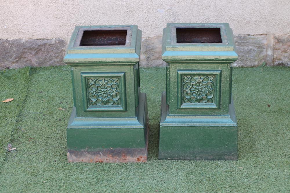 A PAIR OF CAST IRON URN PEDESTALS of stepped square form with floral panels to each side Image