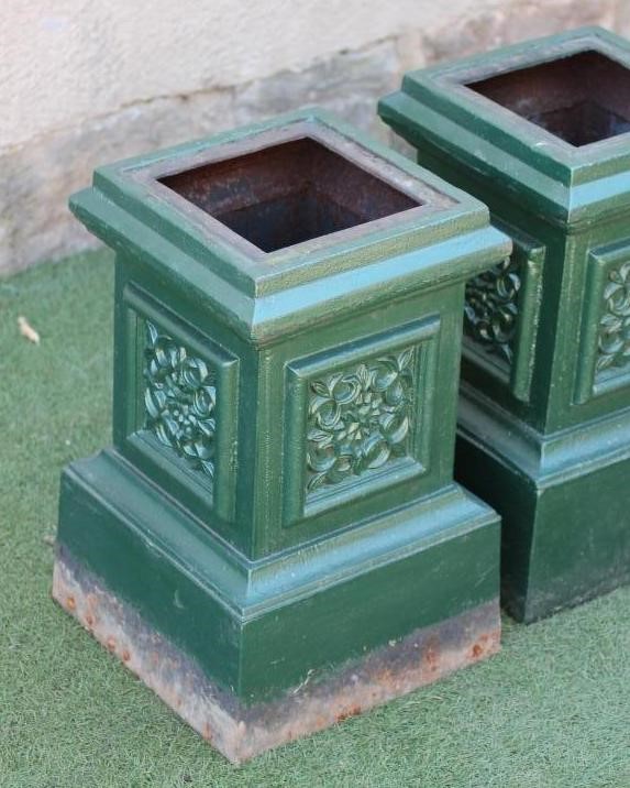 A PAIR OF CAST IRON URN PEDESTALS of stepped square form with floral panels to each side Image