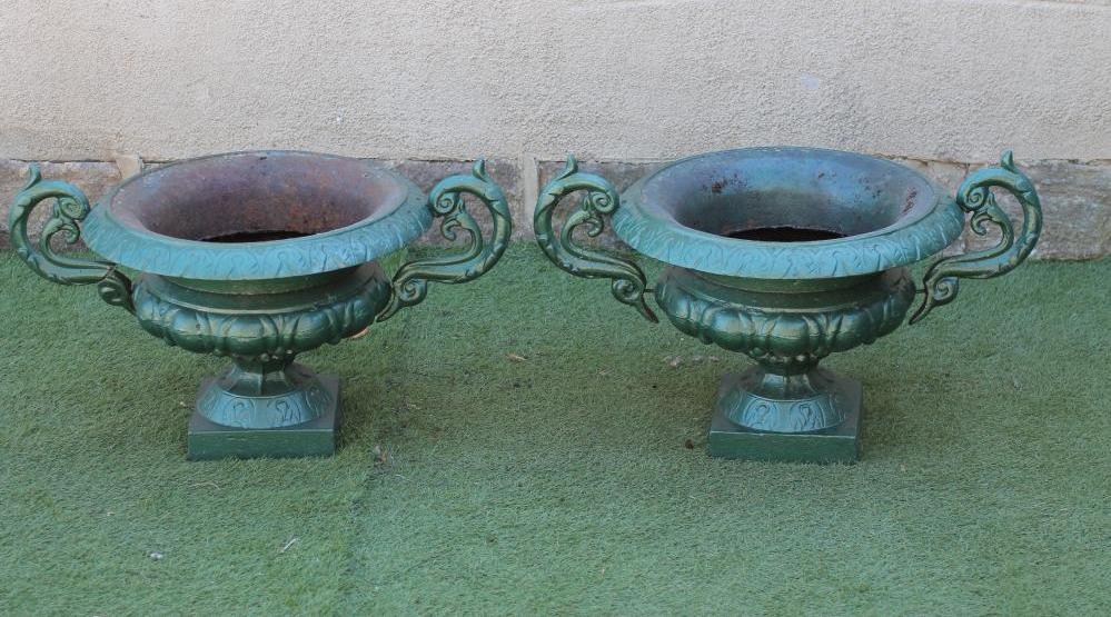 A PAIR OF CAST IRON URNS of shallow campana form with raised foliate scrolled handles Image