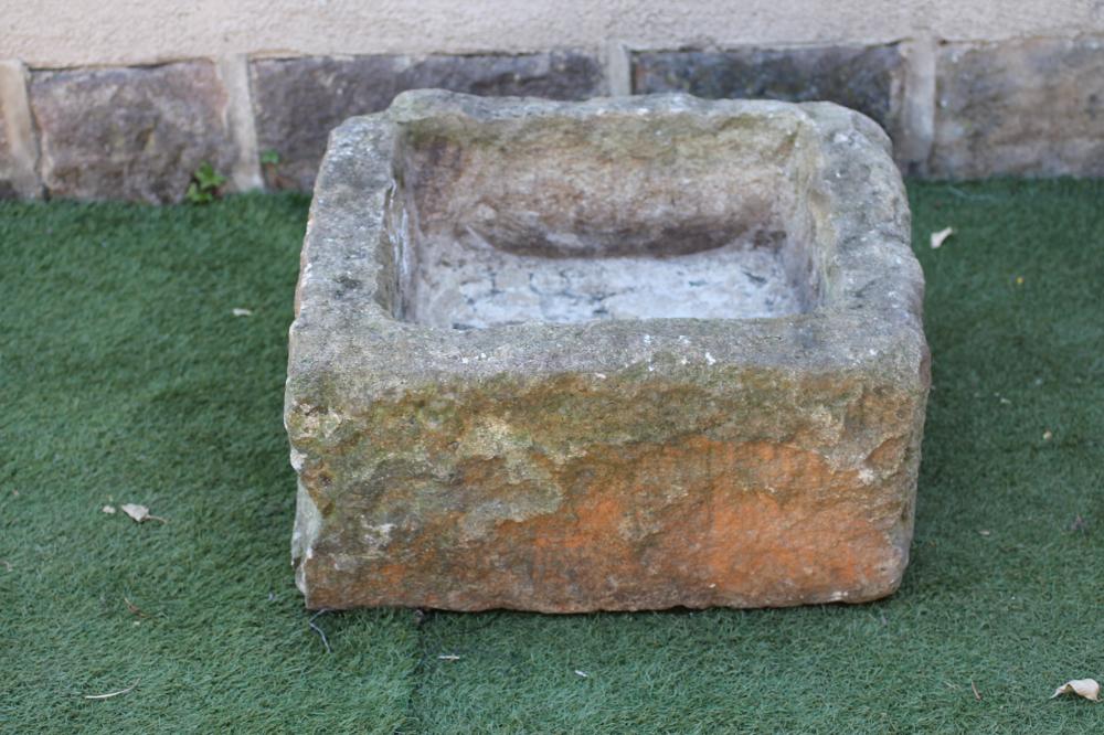 A SANDSTONE TROUGH of rough hewn irregular square form Image