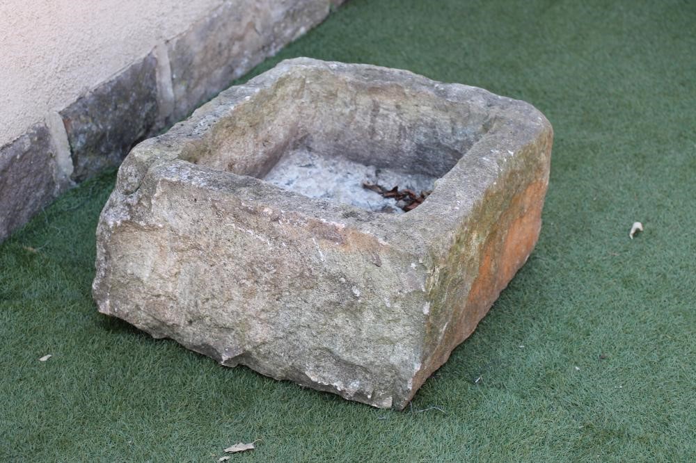 A SANDSTONE TROUGH of rough hewn irregular square form Image