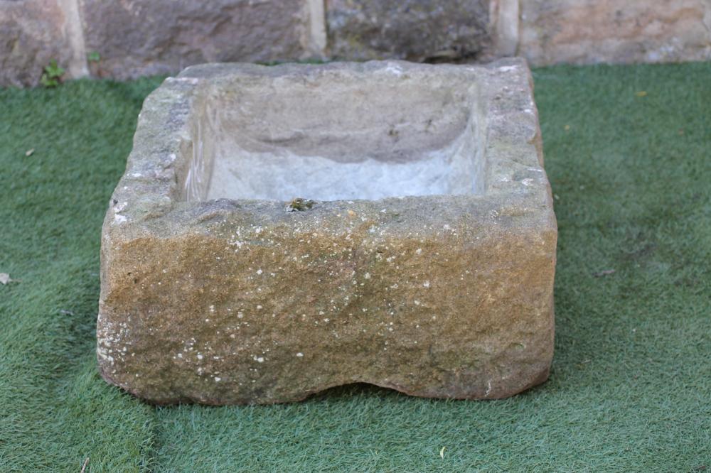 A SANDSTONE TROUGH of rough hewn square form Image
