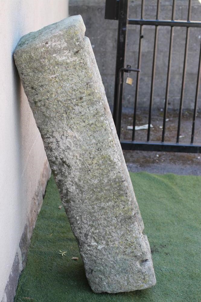 A LARGE GRANITE TROUGH of rough hewn narrow oblong form with mildly tapering sides Image